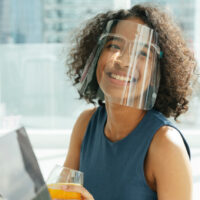 black woman wearing face mask at work
